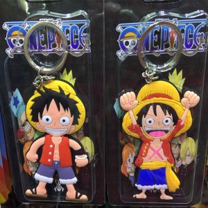 Photo of two different One Piece Luffy keychains in their packaging, taken at a physical store