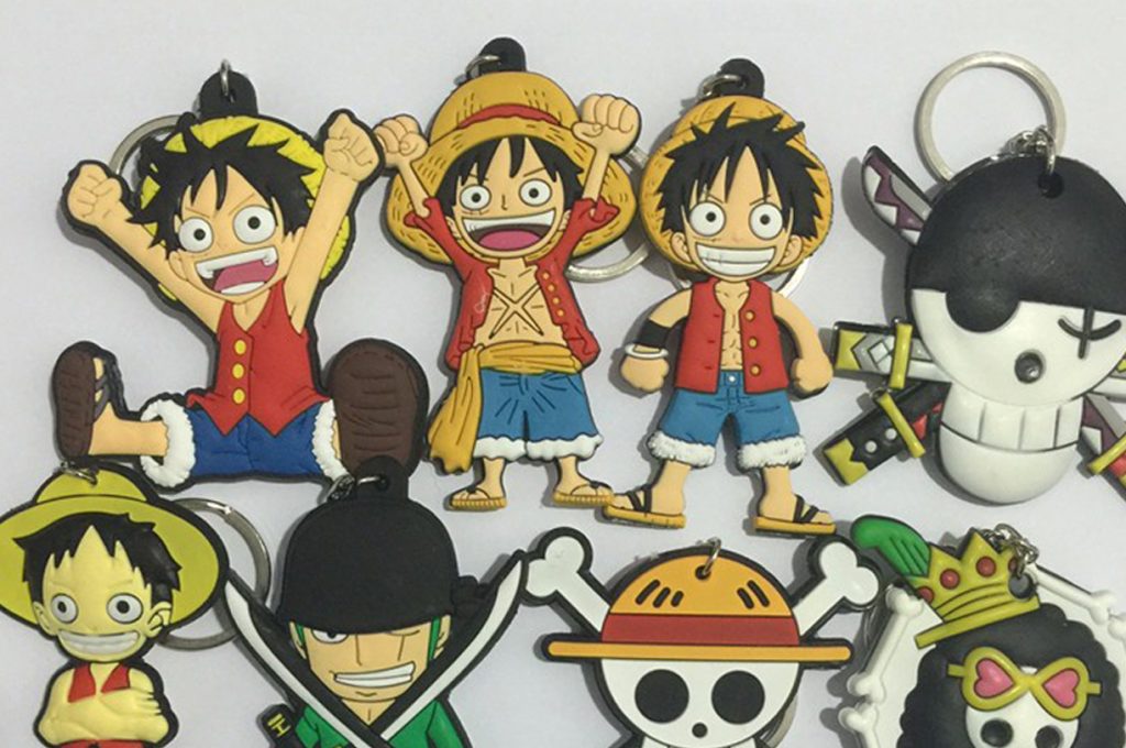 A bunch of poor-quality fake One Piece keychains, including different versions of Luffy and other characters