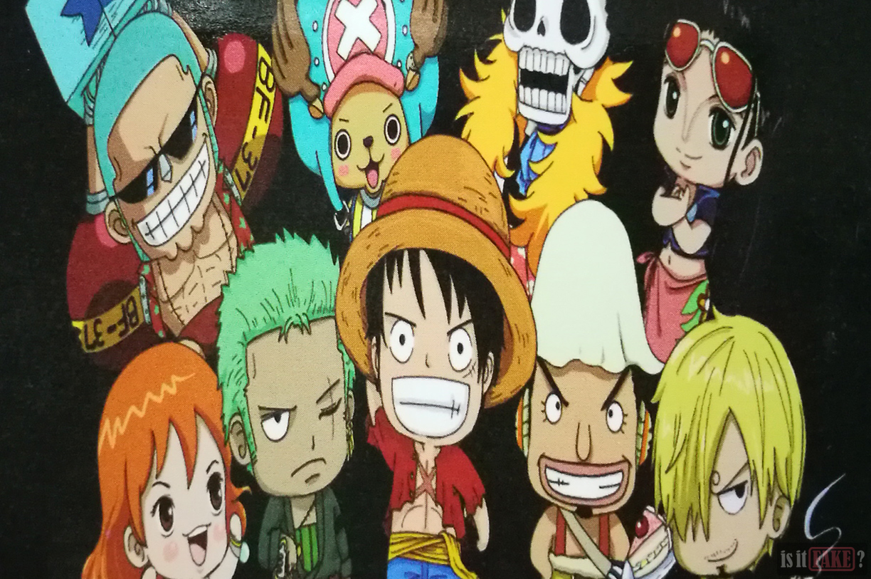 Close-up of the fake One Piece Luffy keychain's cardboard insert, with a focus on the squashed image of the Straw Hat Pirates