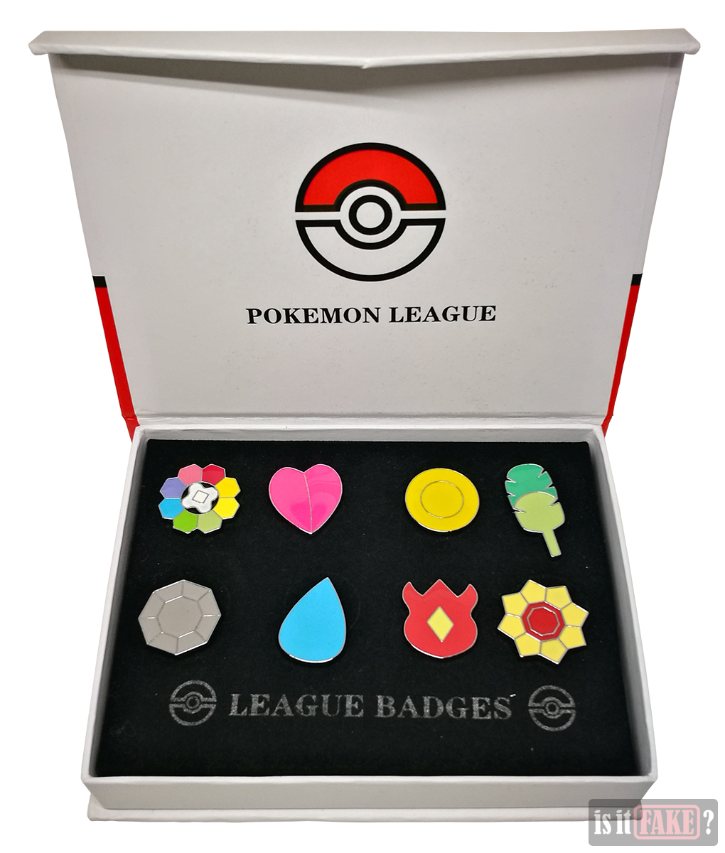 Fake Pokemon badge set box opened to reveal badges fastened to cardboard insert