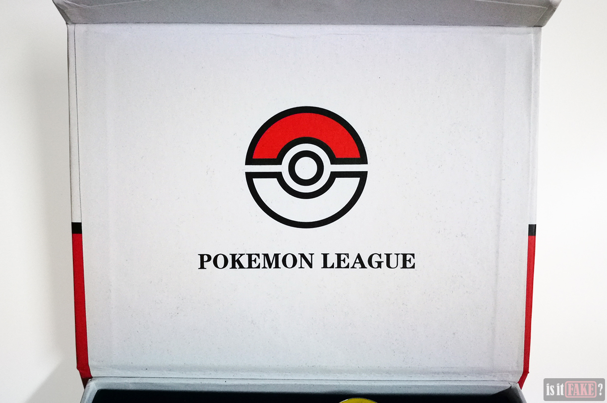 Fake Pokemon badge set box opened to reveal interior of flap