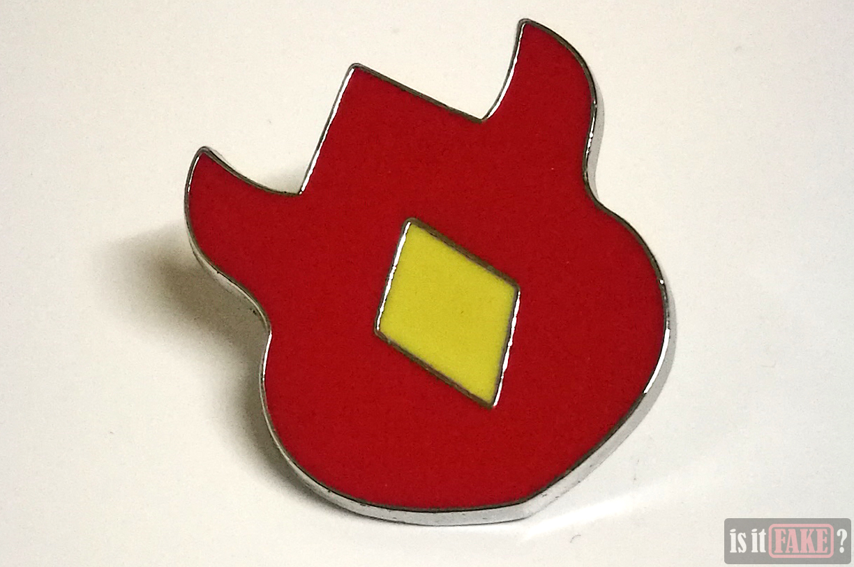 Close-up of fake Pokemon Volcano badge