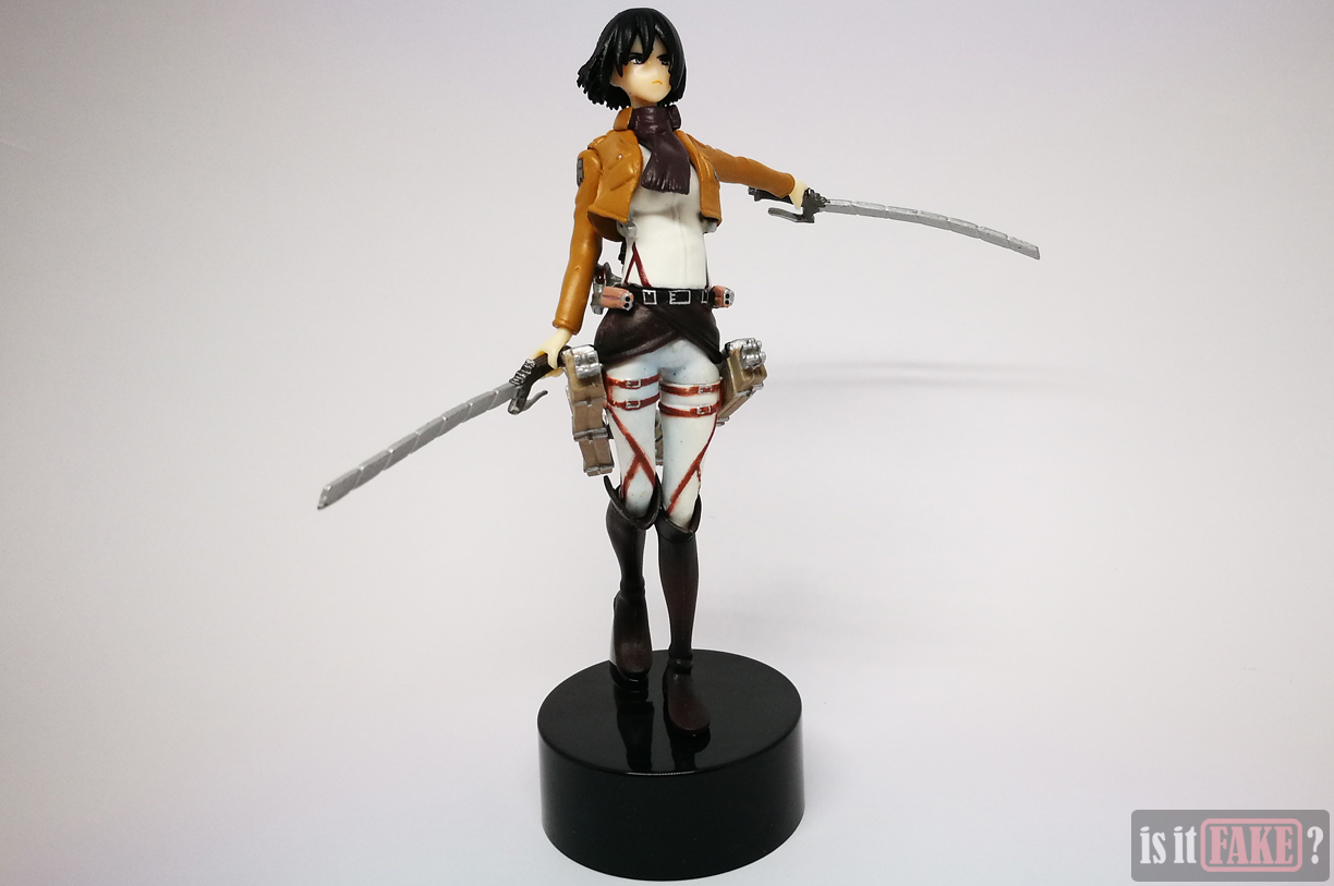 Fake Mikasa figure holding weapons and attached to stand