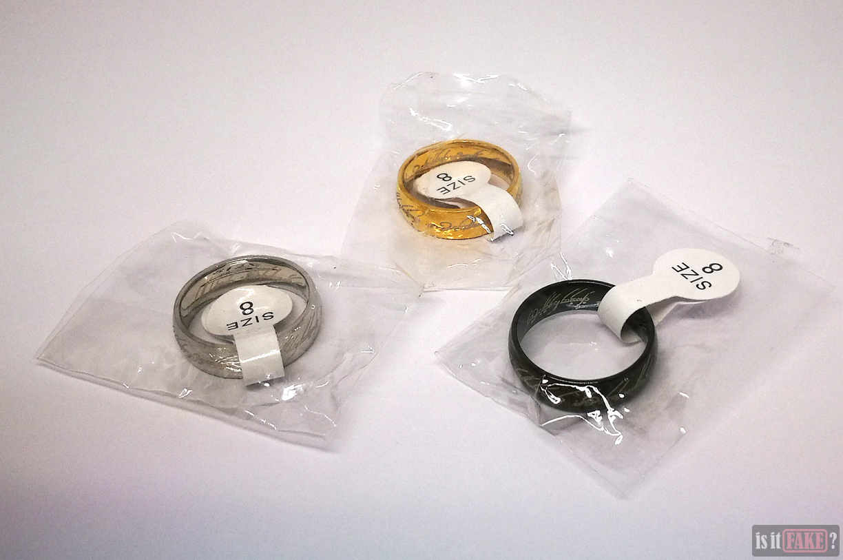 Fake Lord of the Rings gold, silver, and black The One Rings with size tags attached in packets