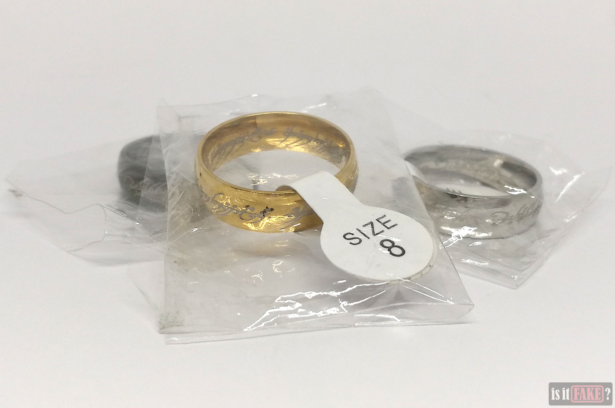 Fake Lord of the Rings gold, silver, and black The One Rings with size tags attached in packets