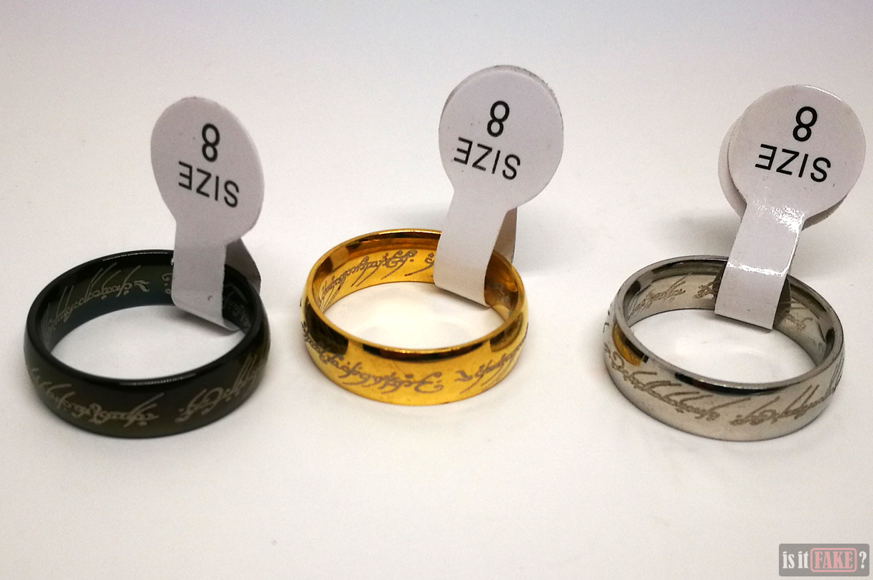 Fake Lord of the Rings gold, silver, and black The One Rings with size tags attached